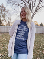 Load image into Gallery viewer, Woman wearing Heather Navy Tee Shirt that reads: Stone, Chamber, Prisoner, Goblet, Order, Prince, Hallows in white block lettering.
