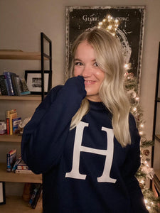 Navy crewneck sweatshirt with large natural colored "H" on the front center.
