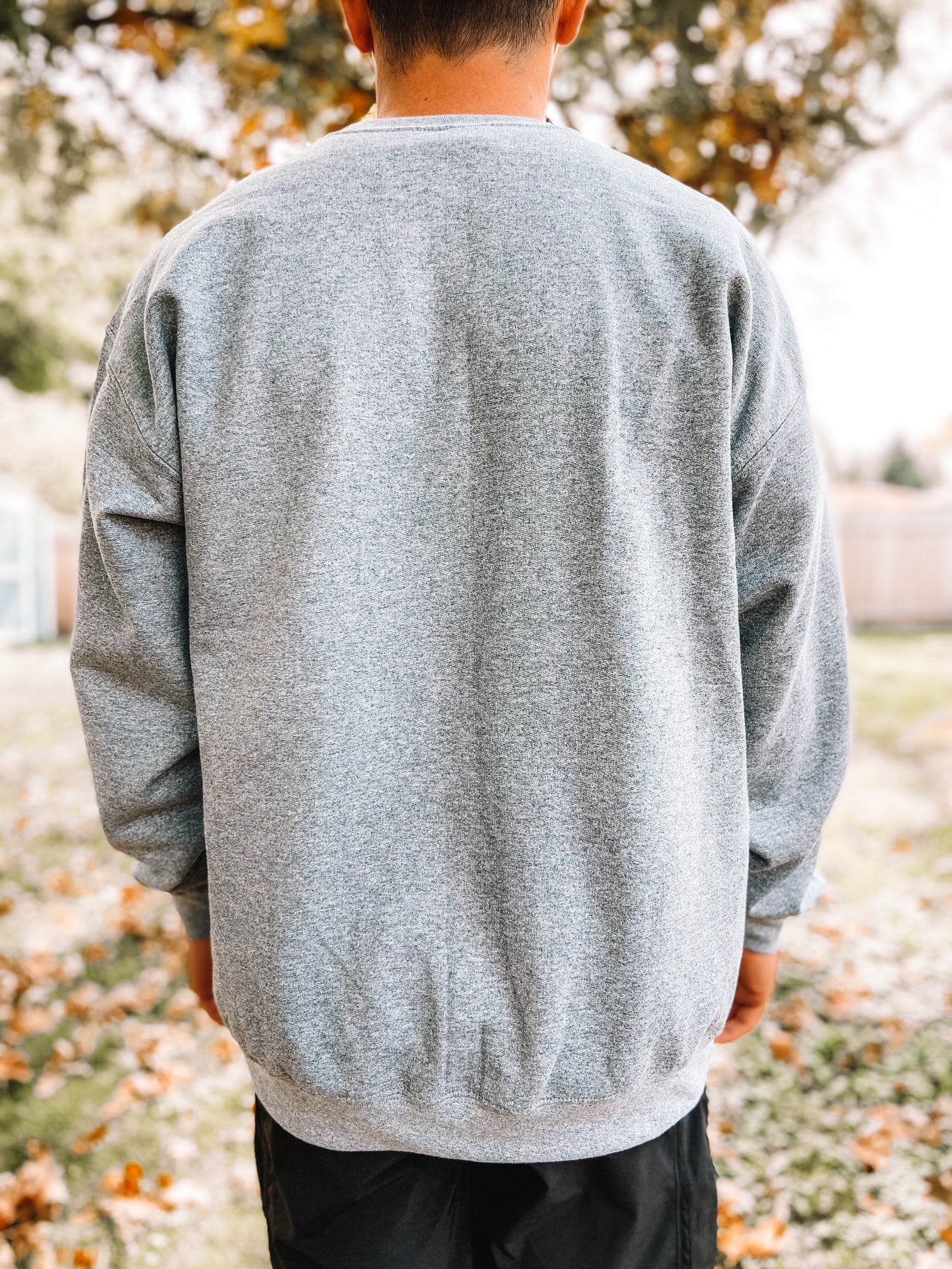 Back of crewneck sweatshirt in charcoal gray.